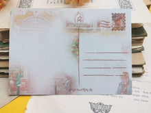 Lade das Bild in den Galerie-Viewer, Postkarte - Buchladen im Schnee - Weihnachten - orange cat bookshop - Aquarell - Cozy - Hund - Katze - Bücher - Eigene Illustration