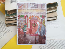 Lade das Bild in den Galerie-Viewer, Postkarte - Buchladen im Schnee - Weihnachten - orange cat bookshop - Aquarell - Cozy - Hund - Katze - Bücher - Eigene Illustration